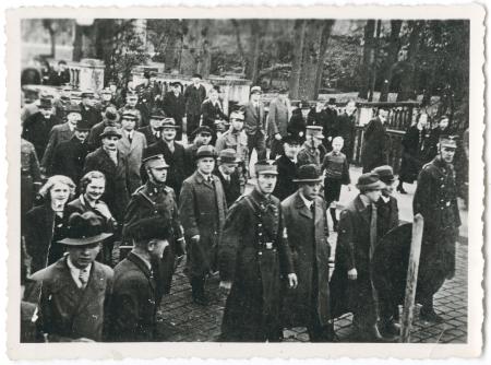 Jews are arrested and transported to a concentration camp as people look on