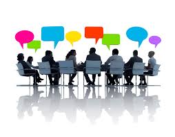 A group of people sitting around a meeting table making decisions