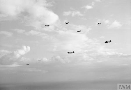 Sixth airborne division fly above the Normandy coast on 6 June 1944. Six planes are flying in formation.