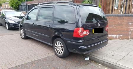 Photograph of vehicle parked partly over dropped kerb