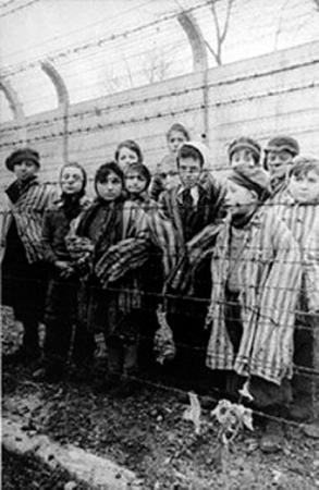 Children behind the barbed wire fences at Auschwitz