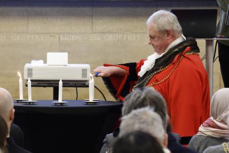 Lord Mayor of Newcastle, Councillor Henry Gallagher, lights a candle at the Holocaust Memorial Day commemorative event
