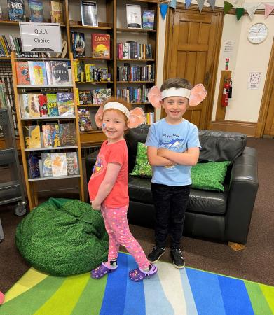 two children with BFG ears in library