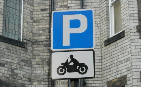 Sign adjacent to motorcycle only bay, has a picture of a motorcycle