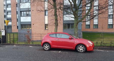 photograph showing vehicle parked over the white bay markings