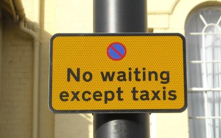 Yellow no waiting sign adjacent to bays states ‘no waiting except taxis’