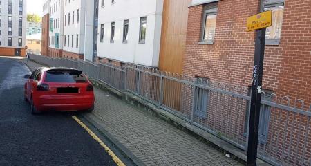 Vehicle parked on a single yellow line, timeplate adjacent to line