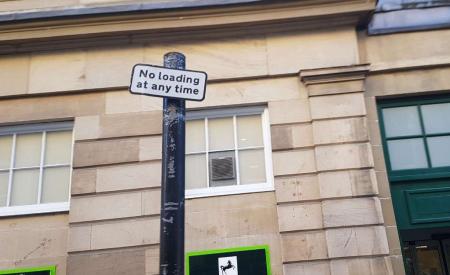 Sign adjacent to double yellow lines and states ‘No loading at any time sign’