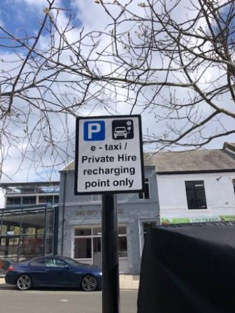 Electric charging sign for Private Hire E-Taxi the sign has a picture of a car charging and states ‘E-Taxi/Private Hire recharging point only