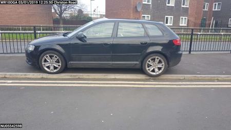 Vehicle parked on pavement adjacent to double yellow lines