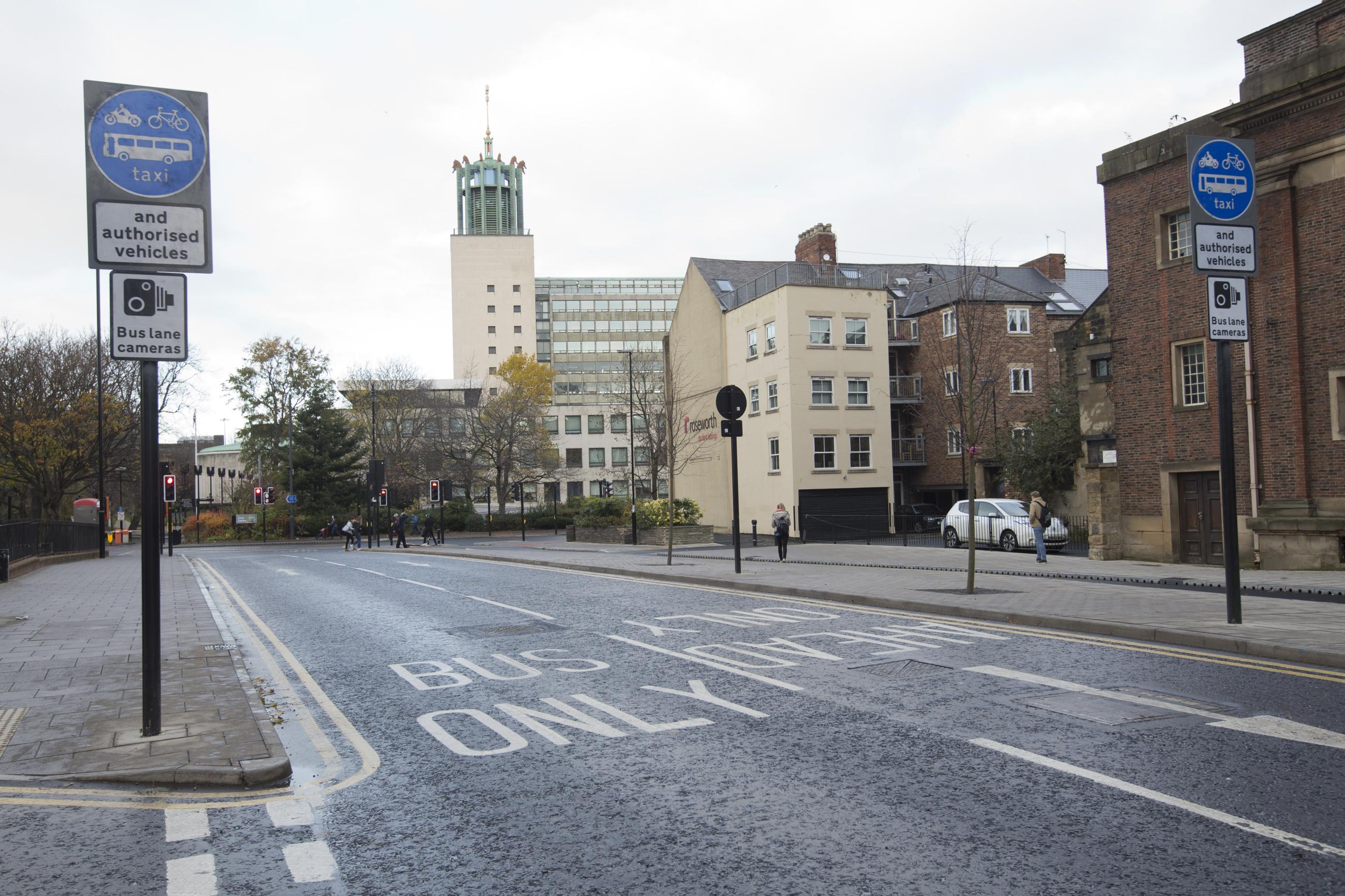 Photo shows a stretch of road with a bus lane on it and the civic centre in the background.