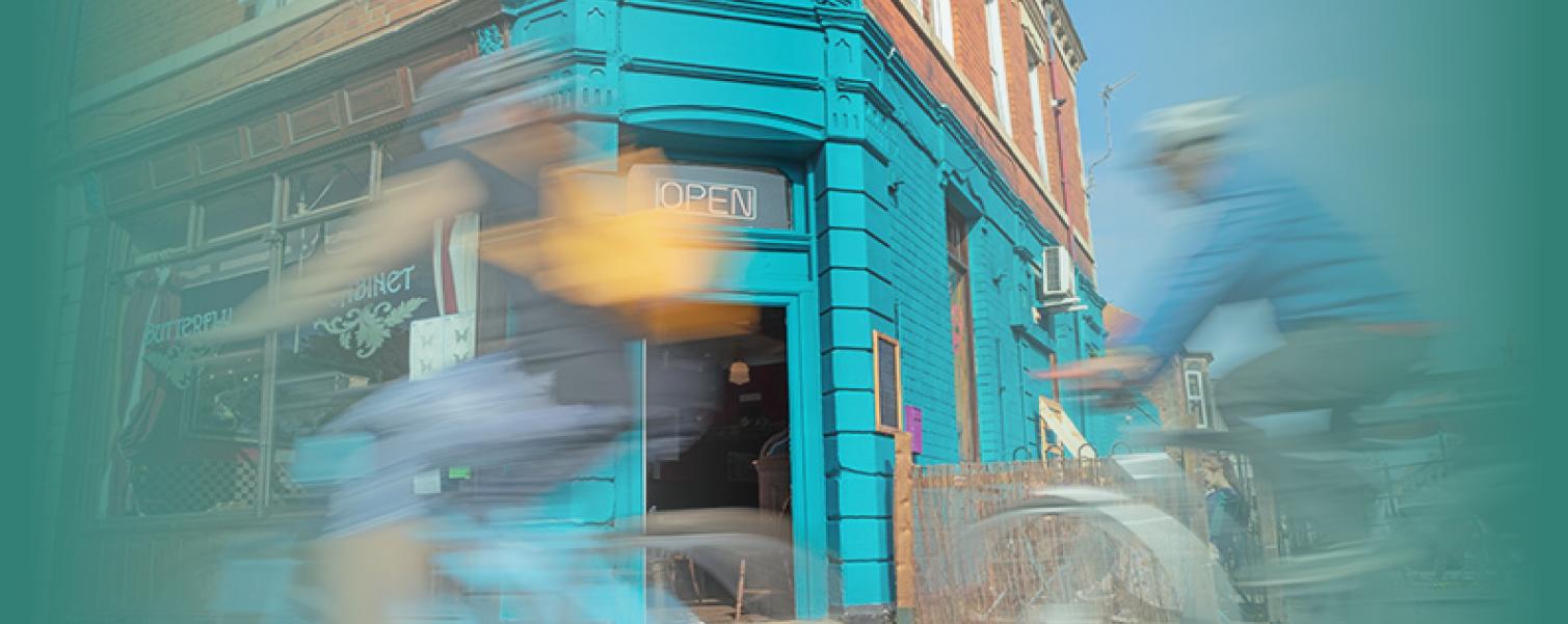 Image of bike cycling past shop