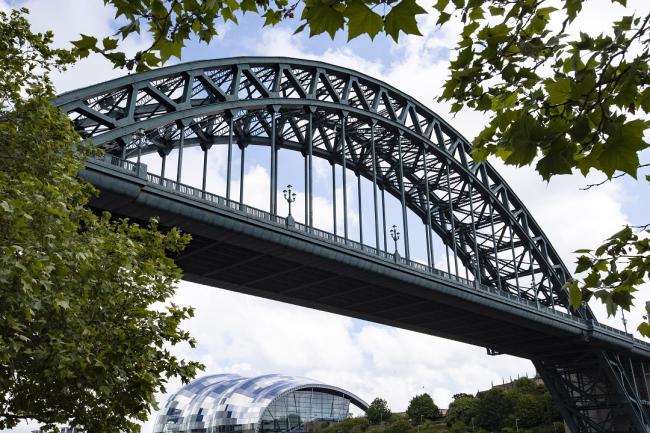 Photo shows the Tyne Bridge with the Sage Gateshead building underneath in the background