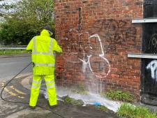 Graffiti is removed from a disused building on Chillingham Road 