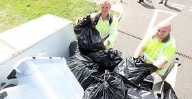 Newcastle City Council staff load bulky waste onto the back of a vehicle