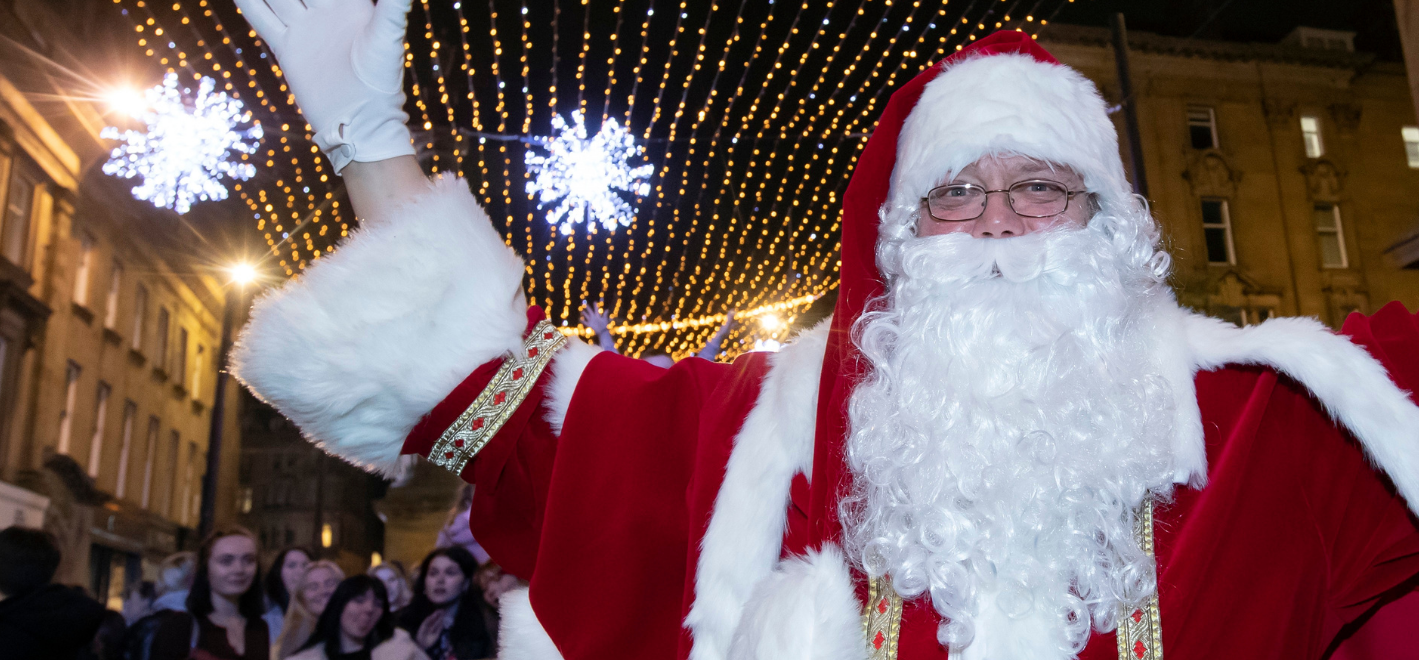 Father Christmas in front of Newcastle's Christmas lights