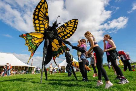Butterfly on stilts at a festival